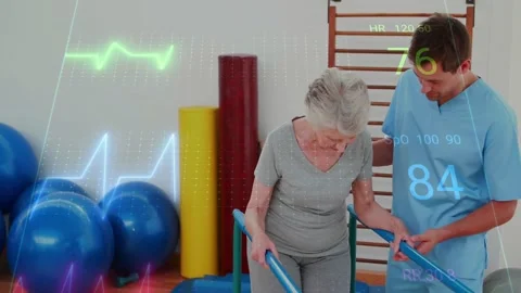 Patient walking on parallel bars in rehab, PT checking wrist monitor, guiding Stock-Footage 323431799