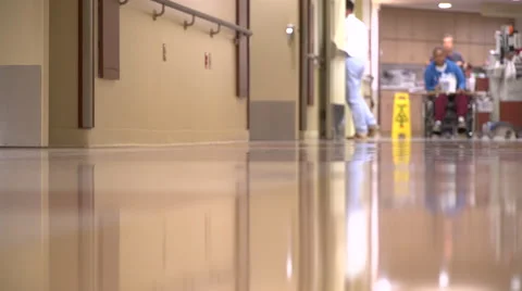 Patient is wheeled down a hall Stock Footage 67384611