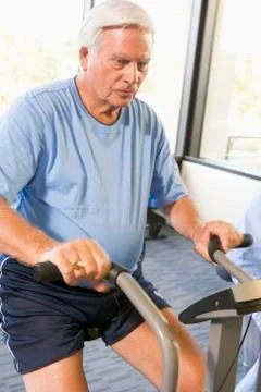 Patient Working Out On Exercise Machine Stock Photos