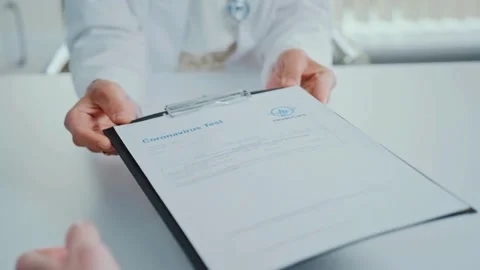 Patient at worktable. Close up young female doctor writing notes in Stock-Footage 336588378
