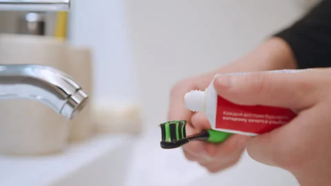 Patiently brushing teeth with colorful toothpaste. Interactive moment capturing Vídeos de archivo 334785900