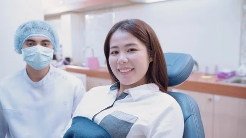 Patients and dentists looking at camera smile Stock Footage 117514554