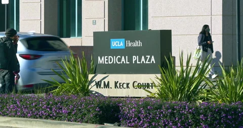 Patients and doctors walking at the UCLA Health Medical Plaza in Westwood, 4K Stock Footage 168415324
