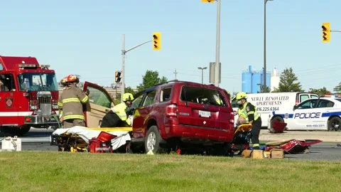 Patients being extricated from both side of vehicle after crash by paramedics 스톡 동영상 133972237