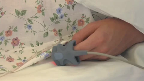 Patients hand in bed with an oximeter. Stock Footage 116616097