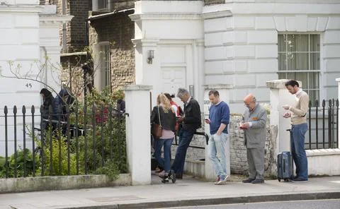 Patients Queue Outside A Doctors Surgery In Notting Hill West London. Picture Da Stock Photos