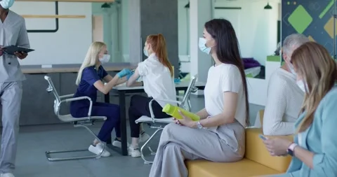 Patients sitting in queue in hospital waiting for mass immunization vaccination Stock Footage 264277794