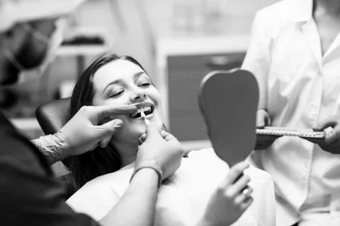 Patient's teeth shade with samples for bleaching treatment. Stock Photos