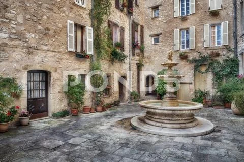Patio with fountain in the old village Tourrettes-sur-Loup Stock Photos