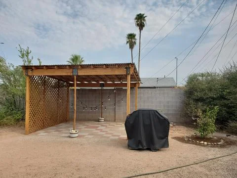 Patio Pergola with Low Hanging String of Solar Lights in Arizona Backyard Stock Photos