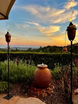 Patio Sunset with Fire Torches Stock Photos