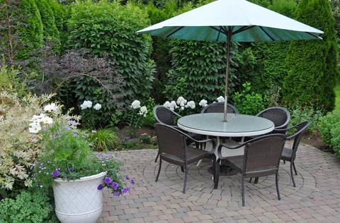 Patio table and umbrella Stock Photos