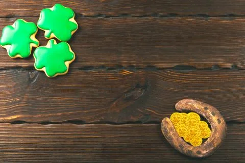 Patrick's day background with gingerbread clover and horseshoe with gold coin Stock Photos