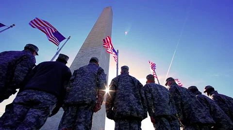 Patriotic American soldiers saluting the flag at Washington Monument Stock Footage