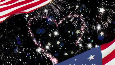 Patriotic fireworks explode over waving flag with glittering sparkles with Stock Footage 340611025