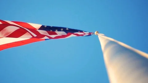 A patriotic low angle slow motion shot of an American Flag Waving Stock Footage 116465529