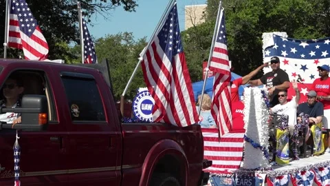 Patriotic parade float with American flags and waving participants 動画素材 340940921