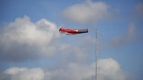 Patriotic windsock on background of blue sky and white clouds. Stripes and stars 스톡 동영상 86529285