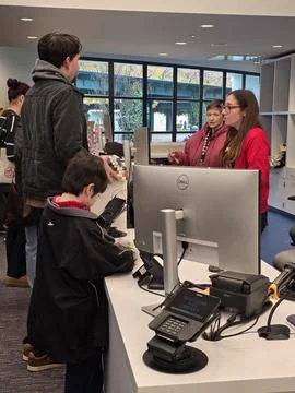 Patron checking out DVDs at the reopening event of the Vacaville Library. Stock Photos