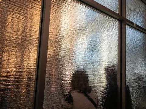 Patrons inside a building standing in a queue Stock Photos