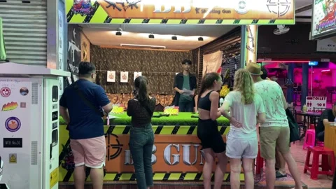 Pattaya, BB GUN storefront at walking street. Tourists shoot gun Stock Footage 237573731