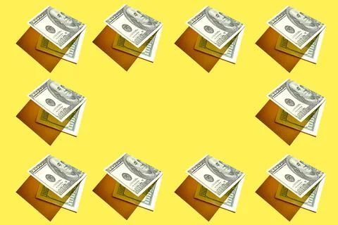 A pattern of 100 American dollar bills on a yellow background with hard light Stock Photos