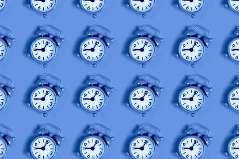 Pattern of alarm clock on blue. Stock Photos