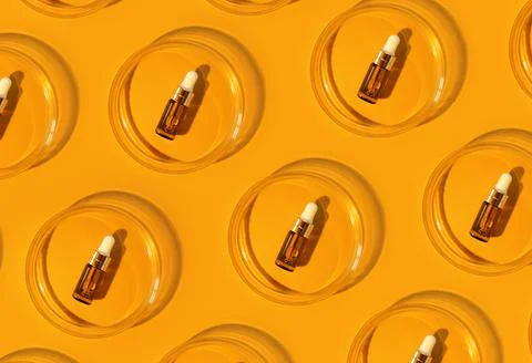 Pattern of Amber bottle. Laboratory glass petri dish with pipette of water Stock Photos