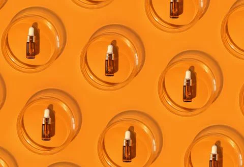 Pattern of Amber bottle. Laboratory glass petri dish with pipette of water Stock Photos