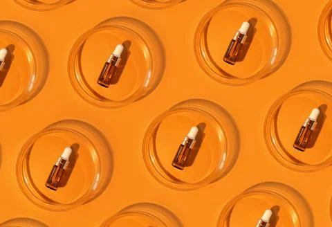 Pattern of Amber bottle. Laboratory glass petri dish with pipette of water Stock Photos