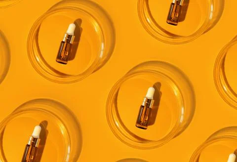 Pattern of Amber bottle. Laboratory glass petri dish with pipette of water Stock Photos