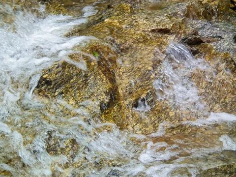Pattern and Texture of Running Water with Bubbles on Wet Rock Stock Photos