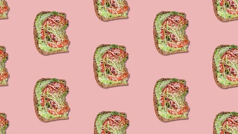 Pattern with avocado toast bite by bite stop motion. Toast with tomato, sprouts Stock Footage 128926252