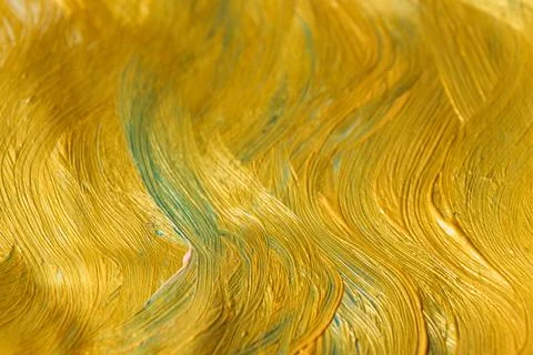 Pattern, background, abstraction of gold paint with vertical wavy stripes. Stock Photos