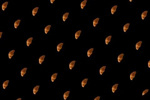 Pattern of baked croissants with a black background. Delicious pastries Stock Photos