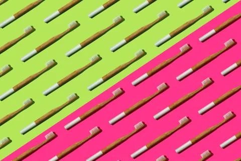Pattern: bamboo toothbrushes on bicolor background Stock Photos