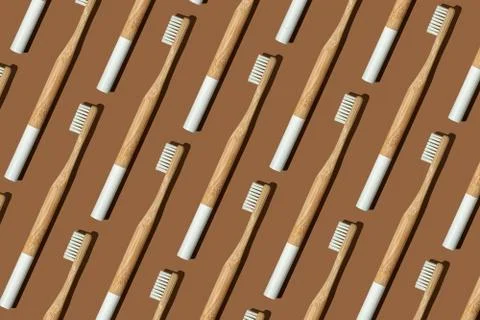 Pattern: bamboo toothbrushes on brown background Stock Photos