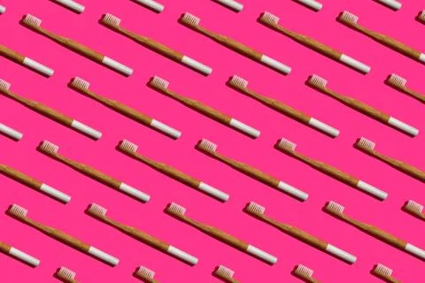Pattern: bamboo toothbrushes on pink background Stock Photos