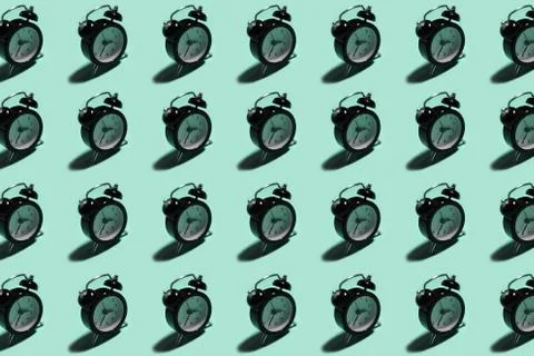 Pattern of black alarm clock on background of aqua menthe color. Stock Photos