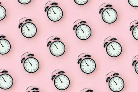 Pattern with black alarm clock on pink background. Minimal style Top view Tem Stock Photos