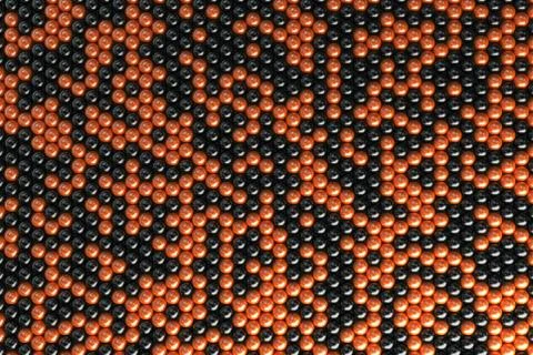 Pattern of black and orange spheres Stock Illustration