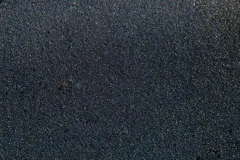 Pattern of black flickering volcanic sand texture. Iceland background Stock Photos