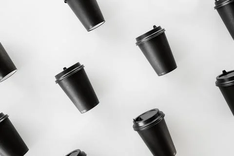 Pattern of black paper cups for tea or coffee on a white background. Recyclin Stock Photos