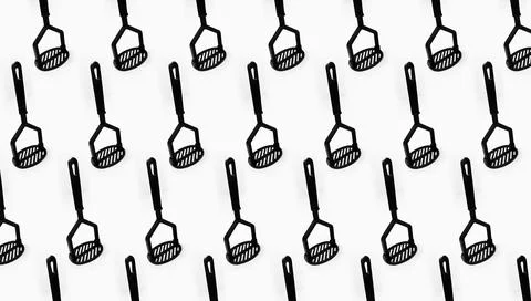 Pattern of black plastic potatoes masher on white background. Stock Photos