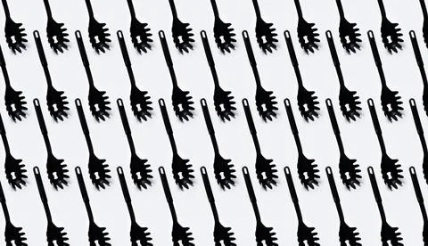 Pattern of black plastic spaghetti spoon on white background. Stock Photos