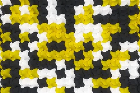 Pattern of black, white and yellow twisted pyramid shapes Stock Illustration
