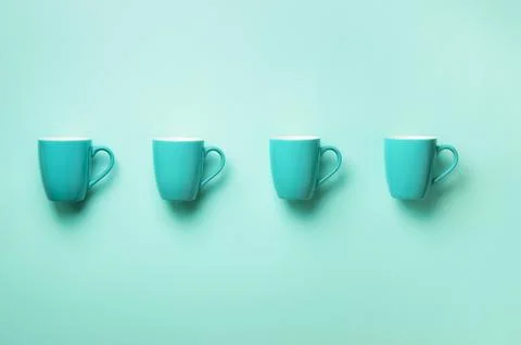 Pattern from blue cups over blue background. Birthday party celebration, baby Stock Photos