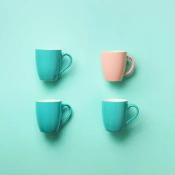 Pattern from blue cups over blue background. Square crop. Birthday party Stock Photos