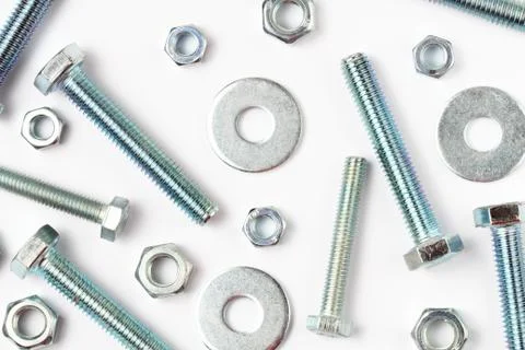 Pattern of bolts, nuts and washers of different sizes on a white background,  写真素材