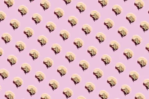 Pattern of brain shaped cookies with small elephant decorations on pink Stock Photos
